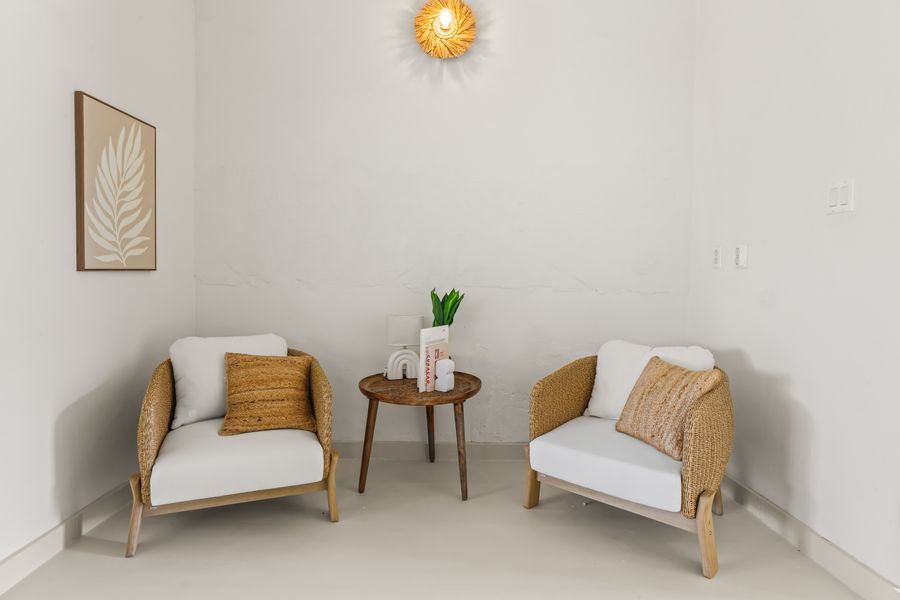 Two rattan armchairs in the reading corner