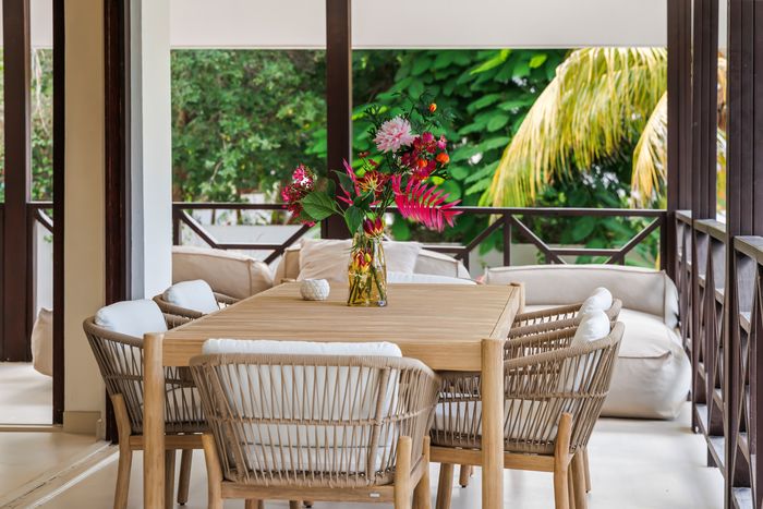 A set table on the veranda with bougainvillea